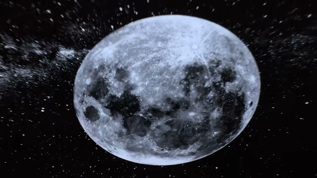 Real starscape and moon projected across a dark bedroom by the Dream-Cycle Galaxy Light